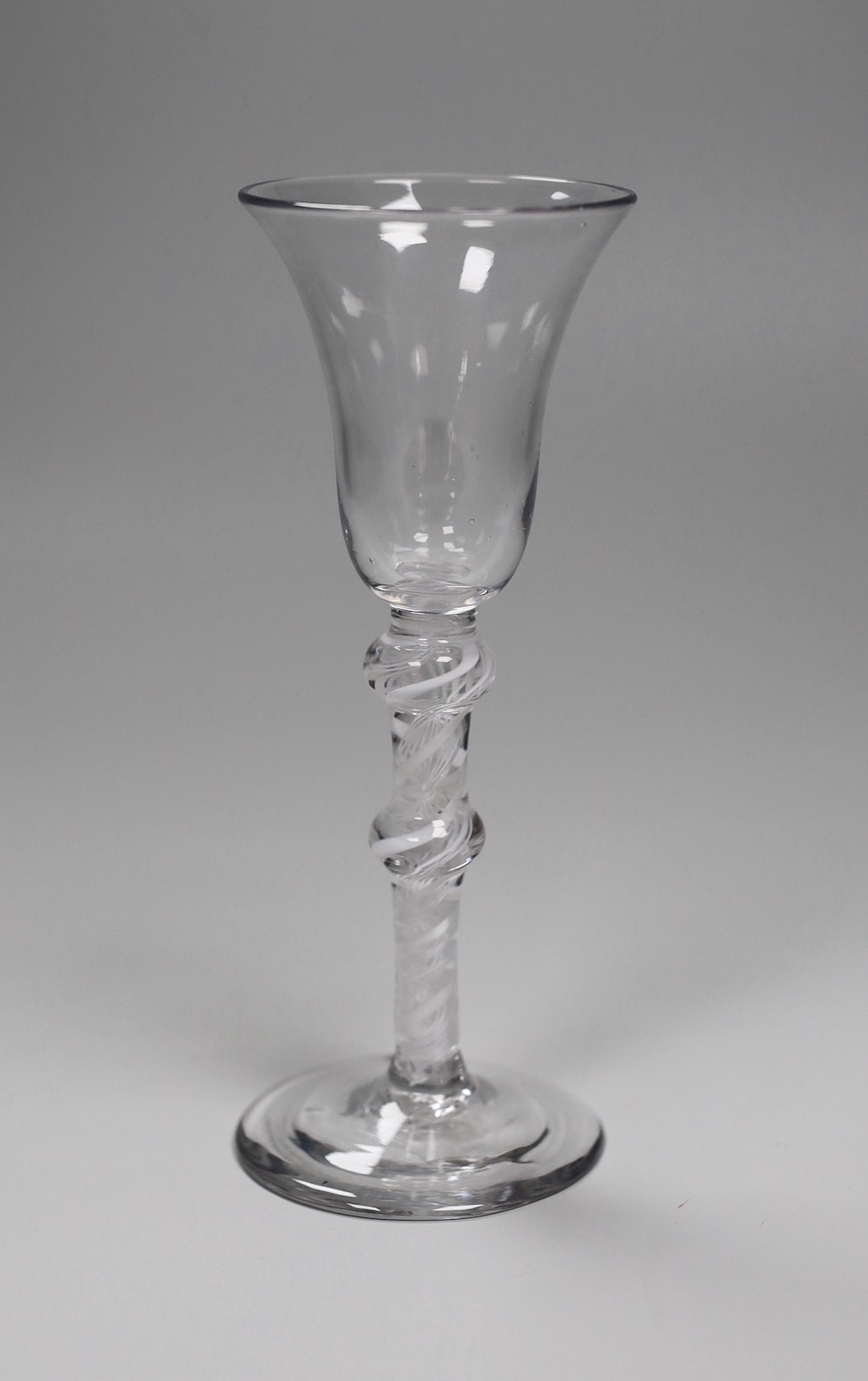 An 18th century double knopped opaque twist stem wine glass. 16.5cm high